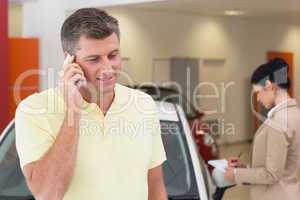 Smiling customer calling with his mobile phone