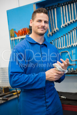 Smiling mechanic looking at camera