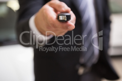 Close up of businessman giving car key