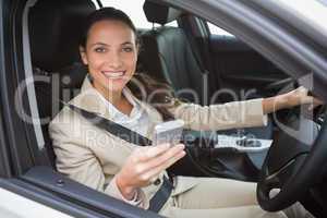 Smiling businesswoman sending a text message