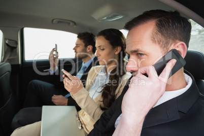 Business team working in the back seat