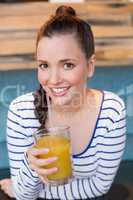 Young woman having glass of orange juice