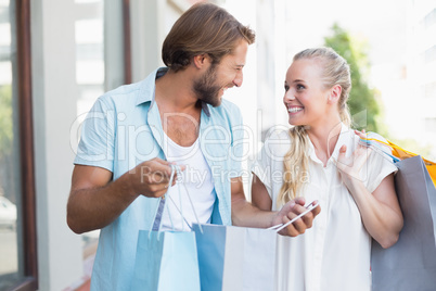 Attractive couple looking at shopping purchases