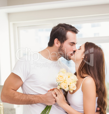 Young man giving girlfriend white roses