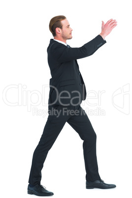 Smiling businessman with his hands up