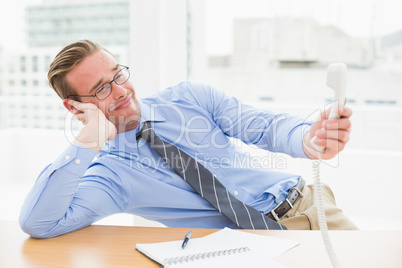 Confused businessman holding the phone