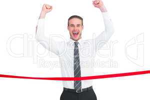 Businessman crossing the finish line and cheering