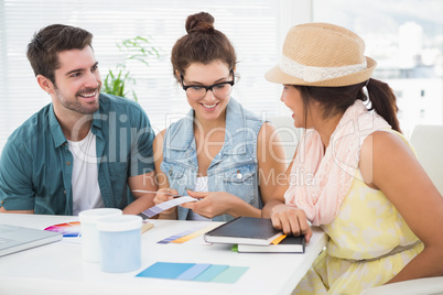Smiling coworkers using colour wheel