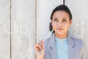 Stylish brunette thinking and smiling