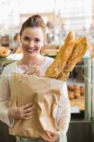 Pretty brunette with bag of bread