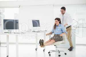 Happy team playing together with swivel chair