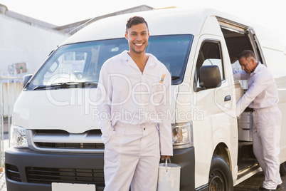 Painter smiling leaning against his van