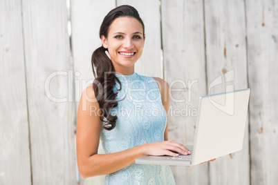 Stylish brunette using a laptop