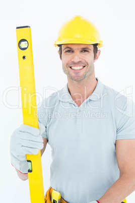 Male carpenter holding spirit level