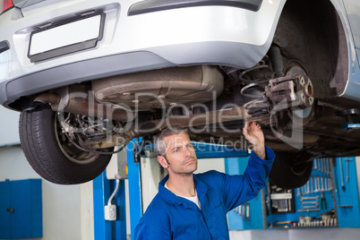 Mechanic examining under the car