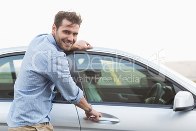 Young man opening the door