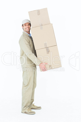 Delivery man carrying stacked cardboard boxes