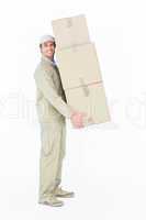 Delivery man carrying stacked cardboard boxes