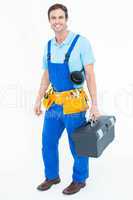 Happy plumber carrying tool box