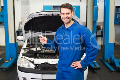 Mechanic holding pair of wrenches