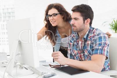 Business people using computer and digitizer