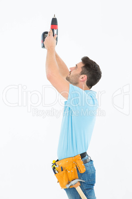 Repairman using hand drill