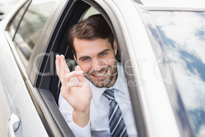 Happy businessman in the drivers seat