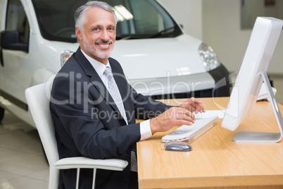 Cheerful businessman working at his desk