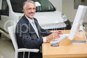 Cheerful businessman working at his desk