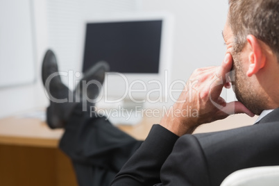 Relaxed businessman with his feet up