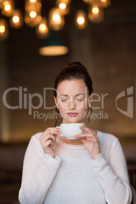 Pretty brunette having cup of coffee