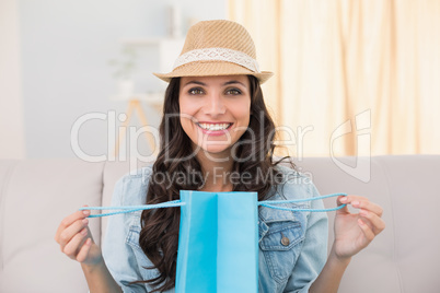 Pretty brunette opening shopping bag