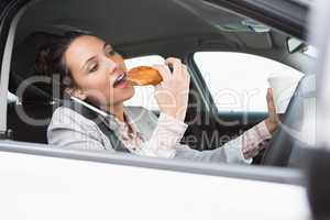 Businesswoman having coffee and doughnut on the phone