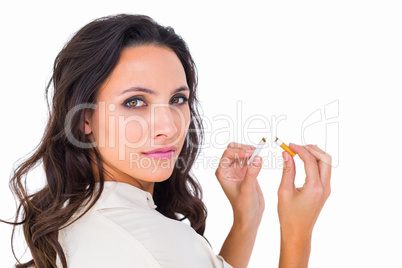 Pretty brunette snapping a cigarette