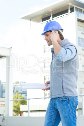 Architect using mobile phone outside building