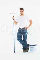 Happy man holding paint roller