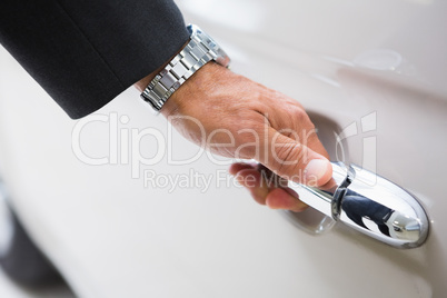 Man holding a car door handles