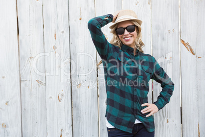 Smiling blonde in striped shirt with sunglasses posing