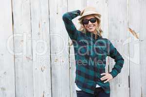 Smiling blonde in striped shirt with sunglasses posing