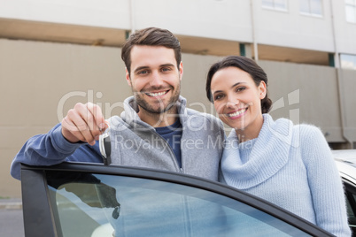 Young couple smiling holding new key