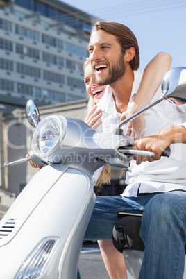 Cute couple riding a scooter