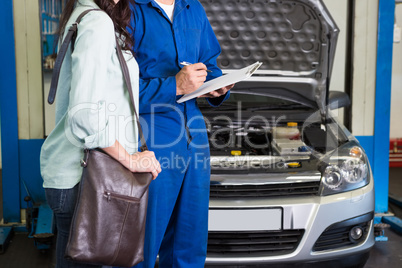 Customer listening to his mechanic