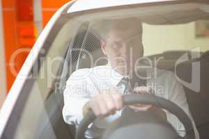 Man sending a text sitting in his car