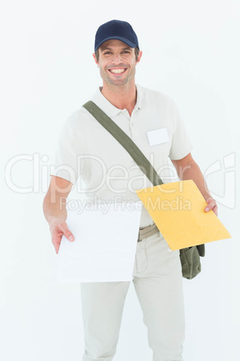 Happy courier man giving parcel