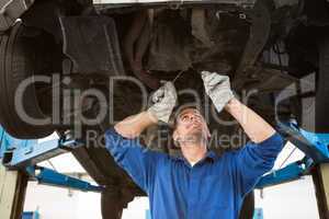 Mechanic examining under the car