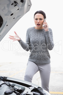 Angry woman calling for assistance after breaking down