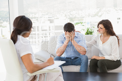 Depressed couple talking with their therapist