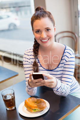 Young woman taking a photo of her lunch