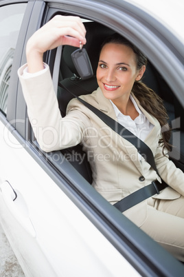 Businesswoman smiling and holding key