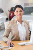 Smiling businesswoman working in her desk